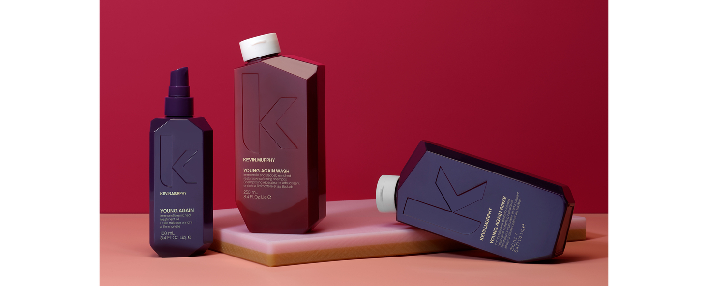 KEVIN.MURPHY YOUNG.AGAIN.WASH & RINSE together with YOUNG.AGAIN oil on a peach and red background.